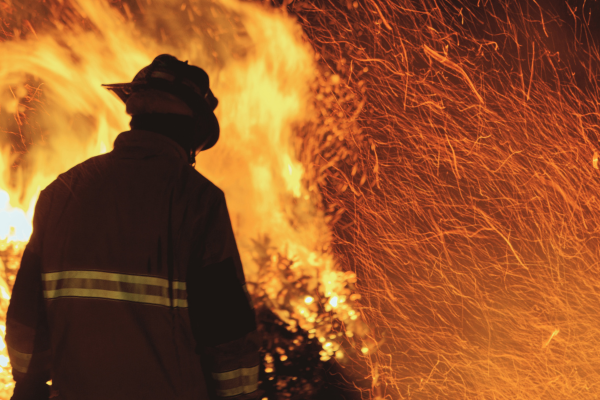 Firefighter in front of a fire