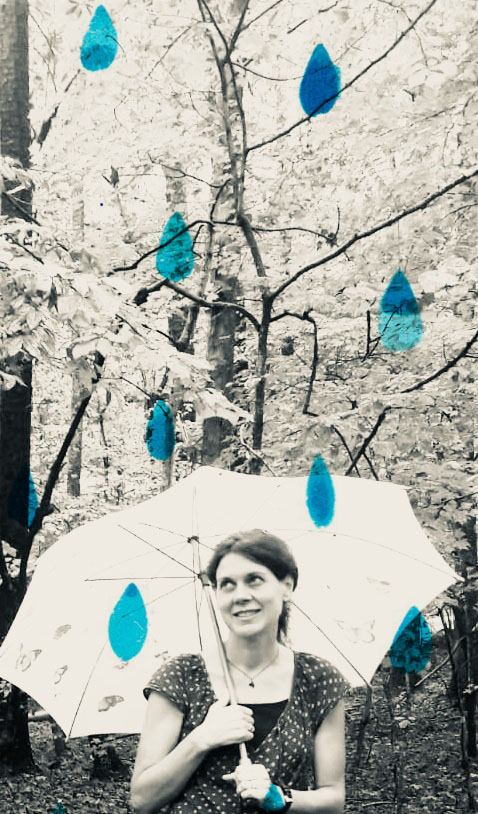 Tatyana Feeney in the rain with an umbrella and blue raindrops